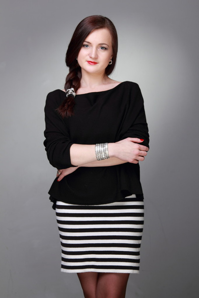 Portrait of a beautiful girl in a striped skirt - Zdjęcie, obraz