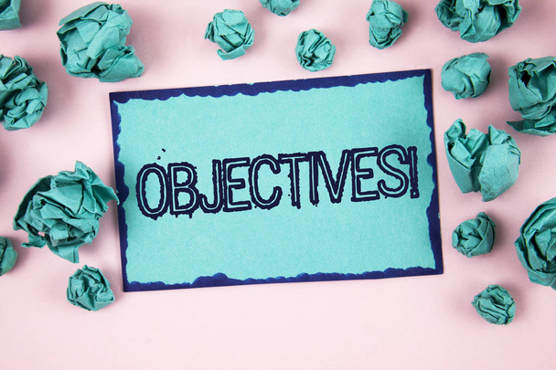 Writing note showing  Objectives Motivational Call. Business photo showcasing Goals planned to be achieved Desired targets written on Sticky Note paper on plain Pink background Paper Balls. - Fotografie, Obrázek