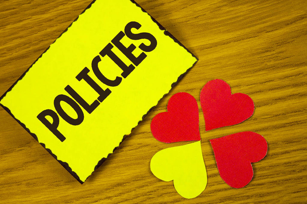 Conceptual hand writing showing Policies. Business photo text Business Company or Government Rules Regulations Standards written on Sticky note paper on wooden background Paper Love Hearts - Foto, afbeelding