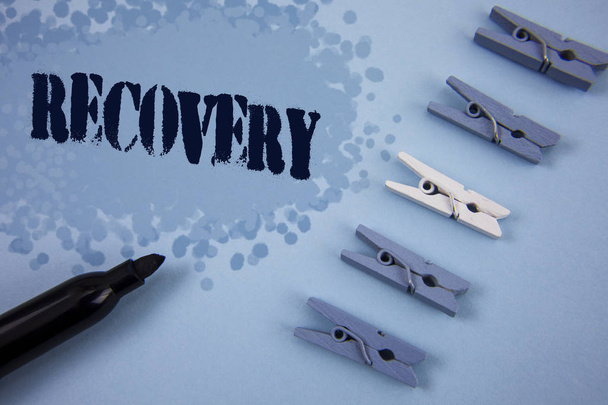 Writing note showing  Recovery. Business photo showcasing Return to normal state of health Regain possession or control written on Painted background wooden Clips and Marker next to it. - Photo, Image
