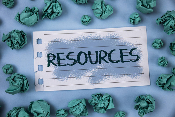Text sign showing Resources. Conceptual photo Money Materials Staff and other assets needed to run a company written on Notepad Paper within Green Paper Balls on Plain Blue background. - Photo, Image
