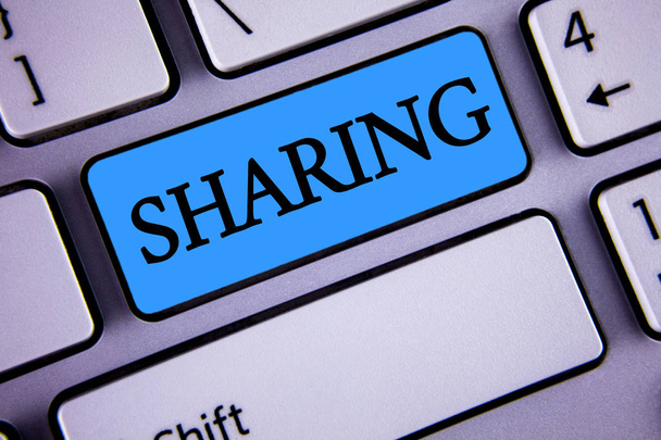 Writing note showing  Sharing. Business photo showcasing To Share Give a portion of something to another Possess in common written on Blue Key Button on White Keyboard with copy space. Top view. - Photo, Image