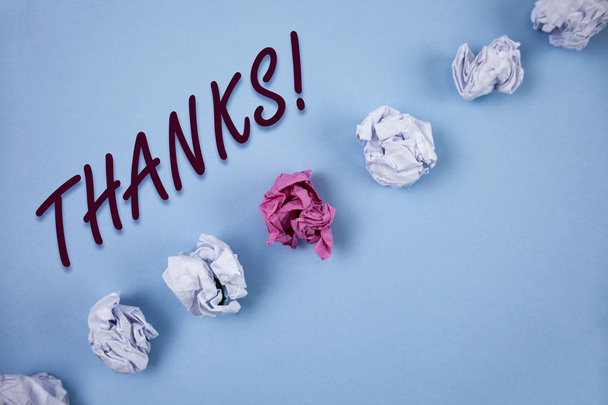 Handwriting text writing Thanks Motivational Call. Concept meaning Appreciation greeting Acknowledgment Gratitude written on Plain Blue background Crumpled Paper Balls next to it. - Photo, Image
