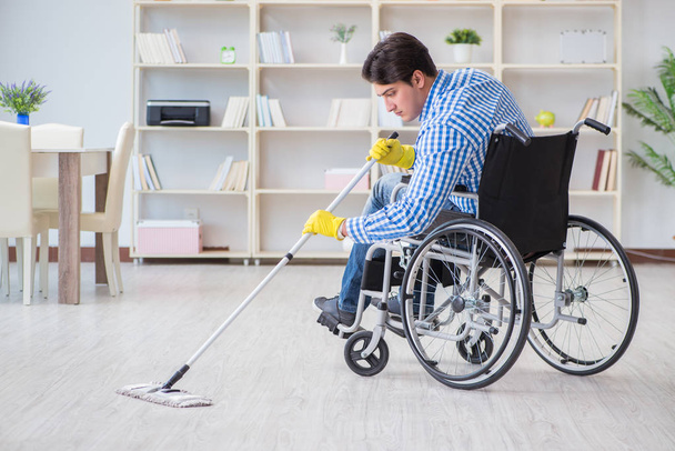 Disabled man on wheelchair cleaning home - Photo, Image