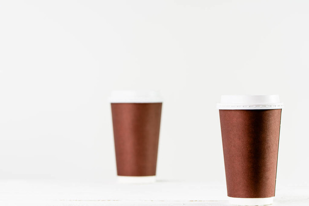 Paper cup to coffee takeaway. Brown cups with lid for safety drinking. - Photo, image