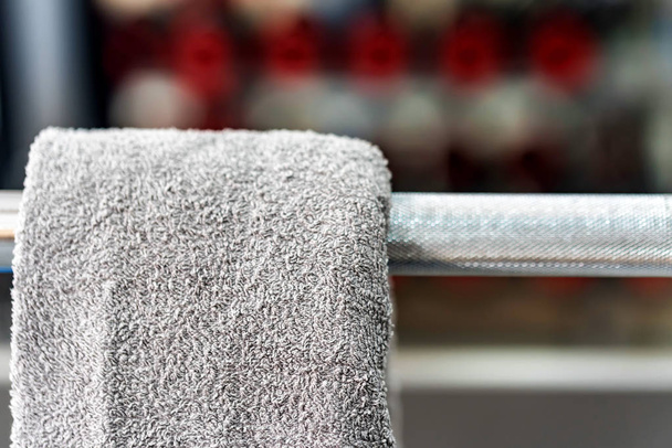 Toalla gris cuelga de la barra en el gimnasio
 - Foto, imagen