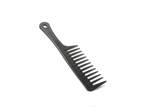Black plastic comb isolated on the white - Photo, Image