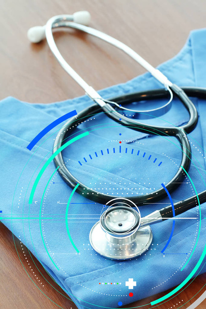 Stetoscopio con cappotto medico blu su tavolo di legno e backgroun
 - Foto, immagini