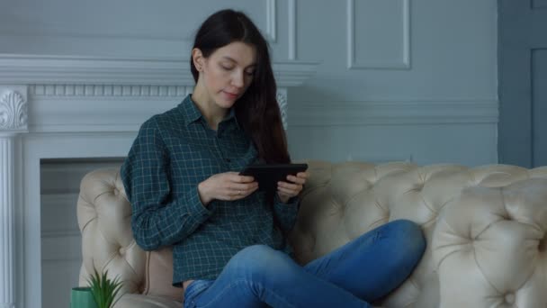 Stunning woman resting with digital tablet at home - Video