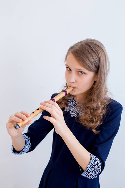 Girl playing on a flute - Foto, afbeelding