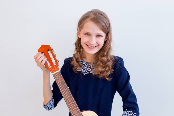 Girl playing a guitar - Фото, изображение