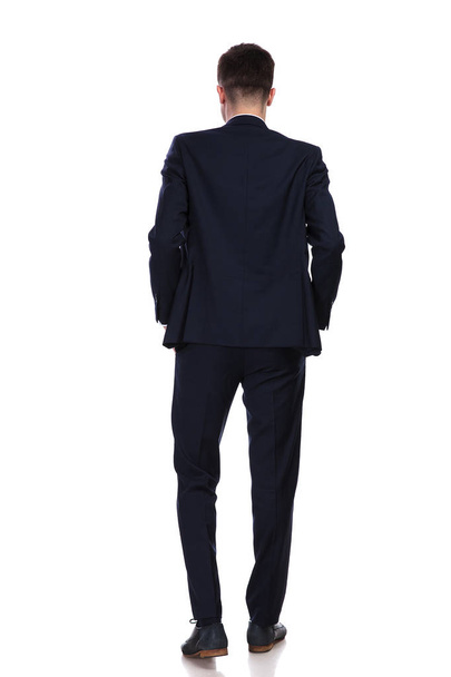 back view of businessman standing with hands in pockets  - Photo, Image