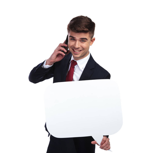 business man on the phone laughs while holding white speech bubbl
 - Фото, изображение