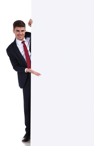 happy businessman presenting board from the side - Photo, Image