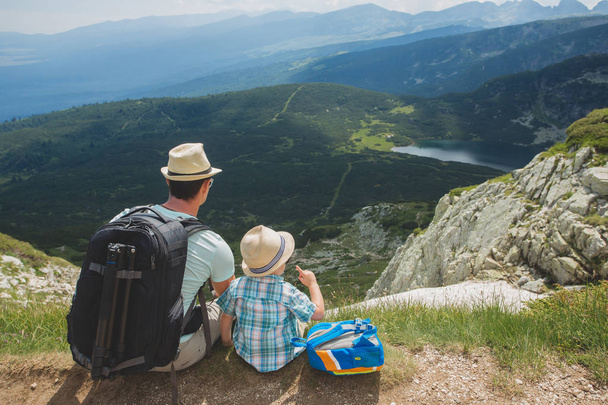 Father and son hiking in Rila mountains, Bulgaria. Back view. - Zdjęcie, obraz