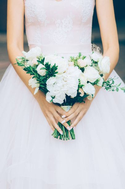 young bride holding a wedding bouquet in the shape of a heart in hands - Photo, Image