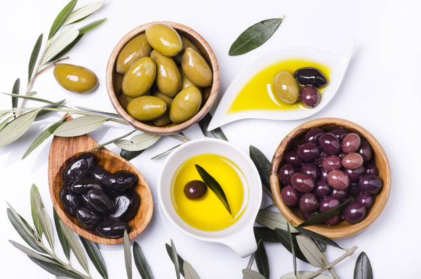 olive wood bowls with different types of olives on white backgro - Fotografie, Obrázek