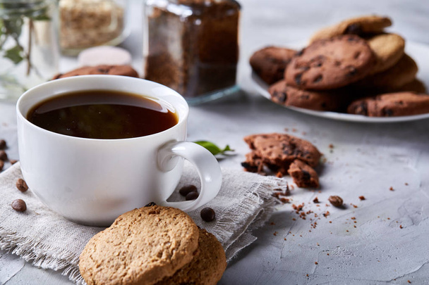 Breakfast background with mug of fresh coffee, homemade oatmeal cookies, grind coffee - Fotografie, Obrázek
