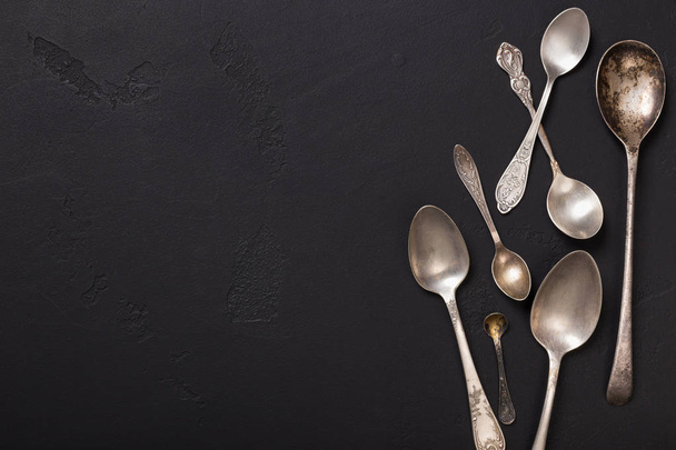 Silver vintage spoons on black backgound, top view - Foto, Imagem