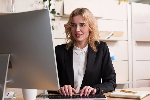 Young woman working in office, sitting at desk - Foto, Imagem
