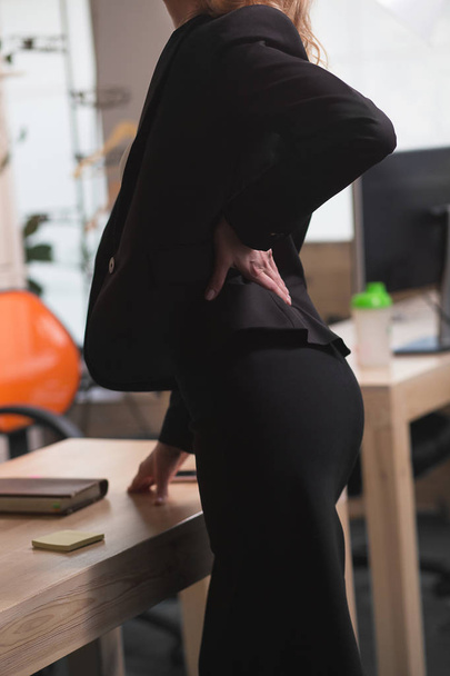 business woman having a back ache - Fotoğraf, Görsel