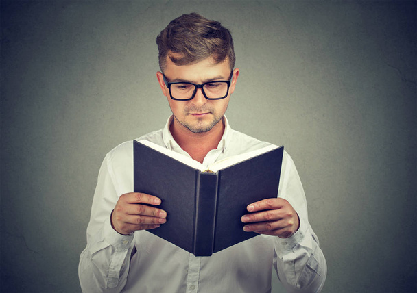 Smart man in glasses reading book - Photo, image