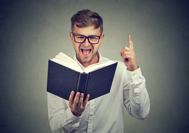 Excited man having answer in book - Photo, image