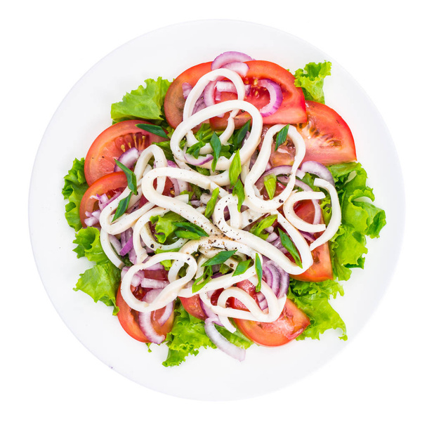 Kalmarirenkaat vihreällä salaatilla ja tomaateilla
 - Valokuva, kuva