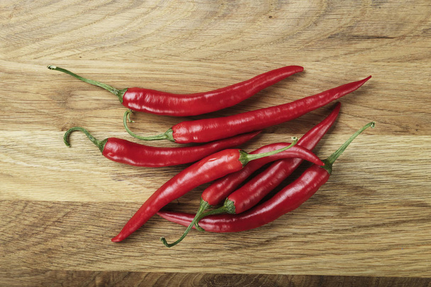 red hot pepper on a wooden background - Foto, Bild