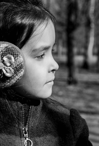 portrait of a girl in profile in warm headphones looking away - Photo, image