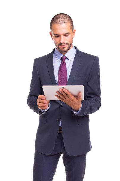 Handsome business man looking to tablet computer, isolated over white background - Fotografie, Obrázek