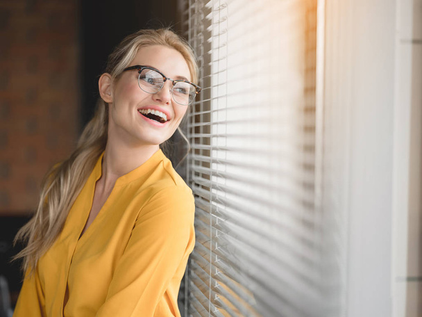 Relaxed blond woman enjoying view from the window - Foto, Imagem