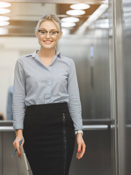 Clever business lady standing near office lift - Fotoğraf, Görsel