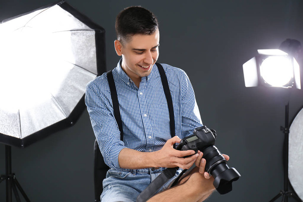 Young photographer working in professional studio - Фото, зображення