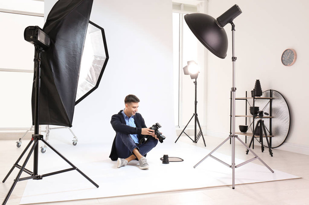 Young photographer working in professional studio - Photo, image