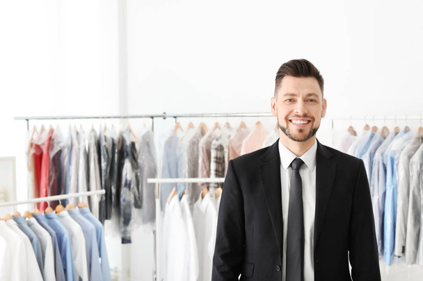 Portrait of young businessman at dry-cleaner's - Photo, Image