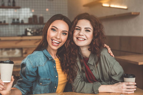 Happy two women enjoying friendly talk in cafeteria - Photo, image