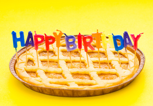 Happy birthday candles in the pie - 写真・画像