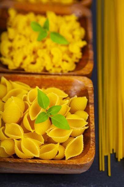 Various pasta in wooden bowls - Photo, image