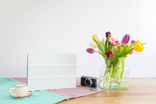 Light box with copy space and flowers on wooden desk with white  - Foto, imagen