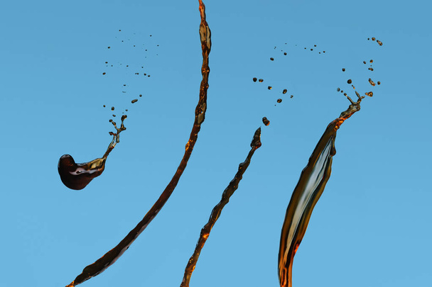 Splashes of black coffee isolated on blue background - Photo, Image