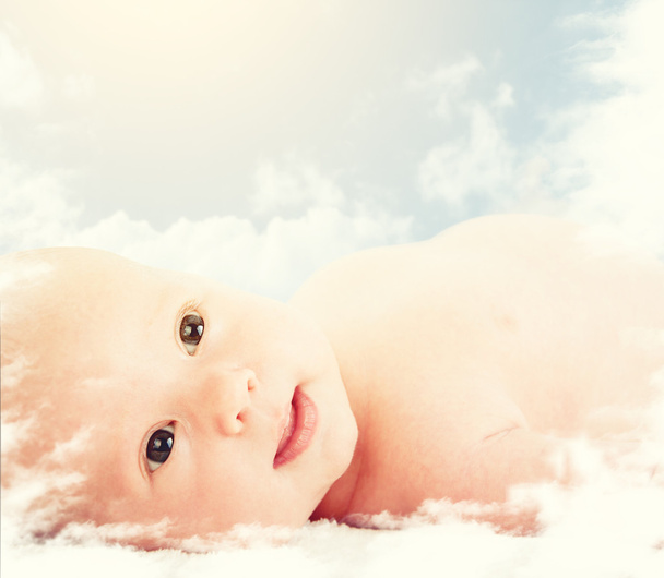 Newborn baby in the clouds in the sky - Photo, Image