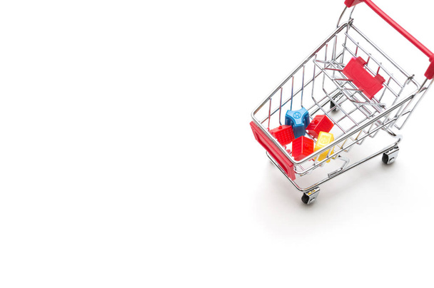 Miniature house and shopping cart on white background : economy  - 写真・画像