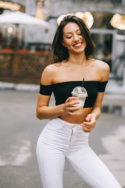 beautiful young woman drinking coffee in the city - Foto, Imagem