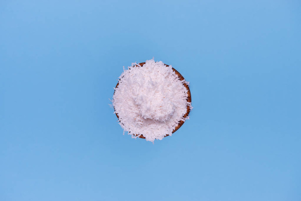 top view of coconut flakes in wooden bowl isolated - Photo, Image