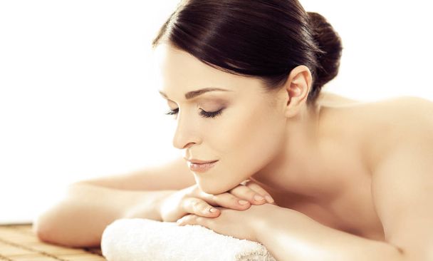 Portrait of a woman in spa. Massage healing procedure. Health care, skin lifting and medical concept. - Foto, Imagen