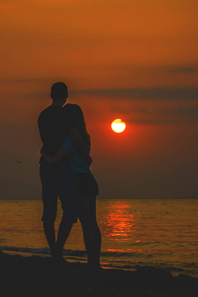 Lovers on the sea looking at the sunset. Selective focus - Photo, Image