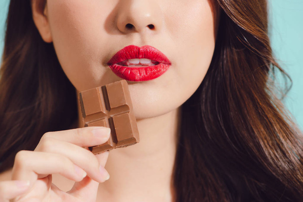 woman eating chocolate, closeup view - Foto, Bild