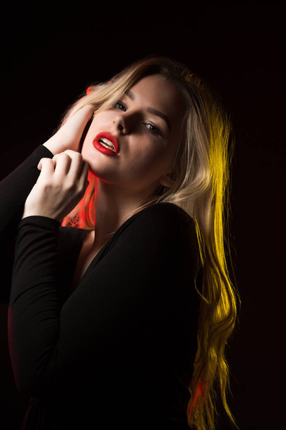 Attractive blonde lady with red lips and long wavy hair posing o - Photo, Image
