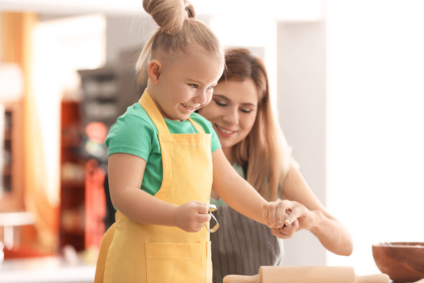 Mother with daughter together in kitchen - Photo, Image